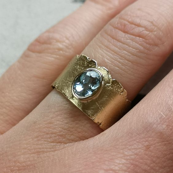 Vintage-style gold ring with blue crystal