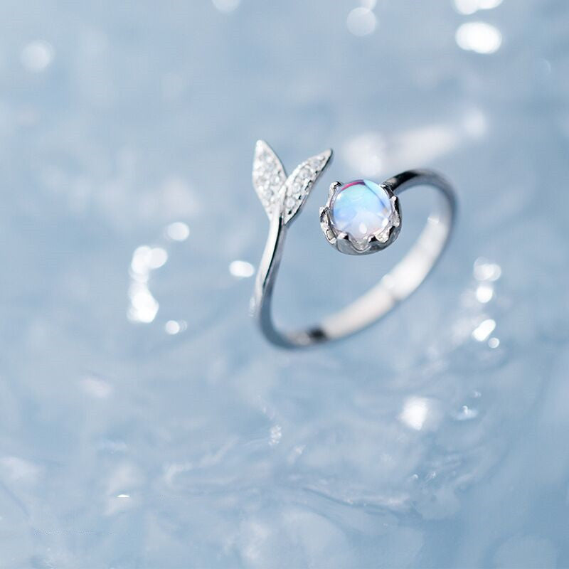 Adjustable ring with dolphin tail made of sterling silver and blue zirconium dioxide