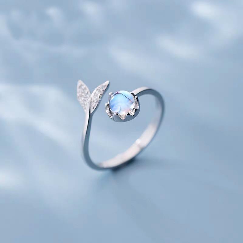 Adjustable ring with dolphin tail made of sterling silver and blue zirconium dioxide